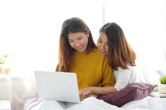 Young cute asia lesbian couple using laptop with happiness at home, lgbt, homosexual, lesbian couple lifestyle royalty free stock photography Young cute asia lesbian couple using laptop with happiness at home, lgbt, homosexual, lesbian couple lifestyle royalty free stock photography