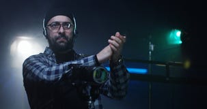 Young director giving instructions on a film set stock photography Young director giving instructions on a film set stock photography