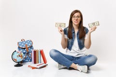 Young dissatisfied woman student hold dollar bills cash money feeling stressed by lack of money sit near globe backpack royalty free stock images Young dissatisfied woman student hold dollar bills cash money feeling stressed by lack of money sit near globe backpack royalty free stock images