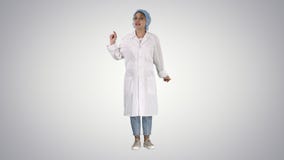 Young doctor woman talking to camera in very emotional way on gradient background. royalty free stock images Young doctor woman talking to camera in very emotional way on gradient background. royalty free stock images