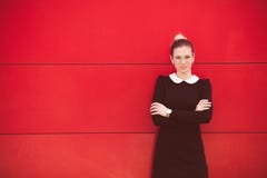 Young elegant business woman portrait stand in front red wall in Royalty Free Stock Images Young elegant business woman portrait stand in front red wall in Royalty Free Stock Images
