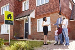 Young Family Collecting Keys To New Home From Realtor royalty free stock photo Young Family Collecting Keys To New Home From Realtor royalty free stock photo