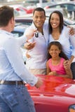 Young family picking up new car