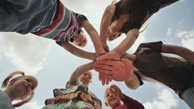 A young family of six join hands together. The concept of a strong and friendly family. stock footage A young family of six join hands together. The concept of a strong and friendly family. stock footage