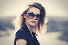 Young fashion blond woman in sunglasses outdoor stock image Young fashion blond woman in sunglasses outdoor stock image