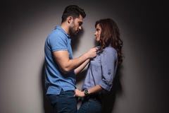 Young fashion couple pulling each other for a kiss. royalty free stock images Young fashion couple pulling each other for a kiss. royalty free stock images