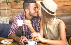 Young fashion lovers couple at beginning of love story - Handsome man kissing beautiful woman at coffee shop bar - Relationship stock photography Young fashion lovers couple at beginning of love story - Handsome man kissing beautiful woman at coffee shop bar - Relationship stock photography