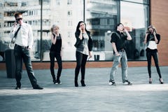 Young Fashion People Calling On The Cell Phones Royalty Free Stock Images Young Fashion People Calling On The Cell Phones Royalty Free Stock Images