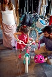 Young father and mother choice new bicycle for little girl in bike shop top view royalty free stock image Young father and mother choice new bicycle for little girl in bike shop top view royalty free stock image