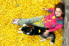 Young Female And Her Dog In Fallen Leaves Royalty Free Stock Photography Young Female And Her Dog In Fallen Leaves Royalty Free Stock Photography