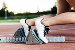Young female athlete launching off the start line in a race. Stock Photography Young female athlete launching off the start line in a race. Stock Photography