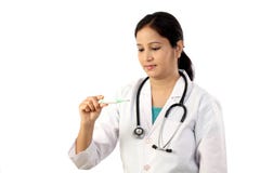 Young female doctor checking fever royalty free stock photography Young female doctor checking fever royalty free stock photography