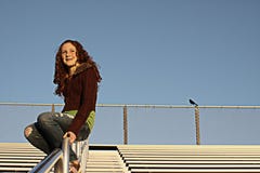 Young Female On Bleachers Royalty Free Stock Image