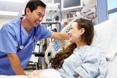 Young Female Patient Talking To Male Nurse In Emergency Room