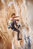 Young female rock climber a face of a cliff stock photo Young female rock climber a face of a cliff stock photo