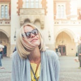 Young female tourist sitting near Cloth Hall in the old city center of Krakow royalty free stock image Young female tourist sitting near Cloth Hall in the old city center of Krakow royalty free stock image