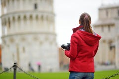 Young female tourist taking photos of the famous Leaning Tower of Pisa stock photos Young female tourist taking photos of the famous Leaning Tower of Pisa stock photos