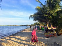 A young female vacationer goes for a peaceful stroll along the sandy beaches of beautiful Placencia, Belize stock photo A young female vacationer goes for a peaceful stroll along the sandy beaches of beautiful Placencia, Belize stock photo