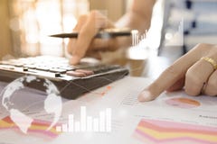 Young Finance Market Analyst Working At Office At White Table.Businessman Analyze Document And The Calculator In Hands Young Finance Market Analyst Working At Office At White Table.Businessman Analyze Document And The Calculator In Hands