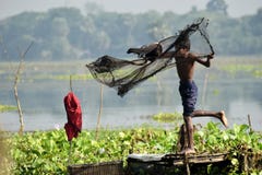 Young fisherman throwing fishing net stock image Young fisherman throwing fishing net stock image
