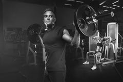 Young and fit couple in the gym doing workout stock photos Young and fit couple in the gym doing workout stock photos