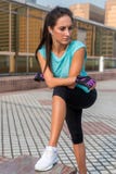 Young fit woman taking a break after exercising or running. Fitness girl standing and resting outdoors on city street. royalty free stock photo Young fit woman taking a break after exercising or running. Fitness girl standing and resting outdoors on city street. royalty free stock photo