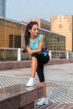 Young fit woman taking a break after exercising or running. Fitness girl standing and resting outdoors on city street. stock photos Young fit woman taking a break after exercising or running. Fitness girl standing and resting outdoors on city street. stock photos