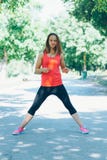 Young fitness woman exercising in park Stock Images Young fitness woman exercising in park Stock Images