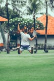 Young freelancer man jumping with laptop in the tropical park of Bali island. stock image Young freelancer man jumping with laptop in the tropical park of Bali island. stock image