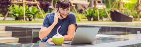 Young freelancer working on vacation next to the swimming pool BANNER, long format stock photography Young freelancer working on vacation next to the swimming pool BANNER, long format stock photography