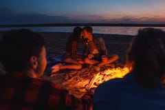 Young friends have picnic with bonfire on the beach royalty free stock photos Young friends have picnic with bonfire on the beach royalty free stock photos