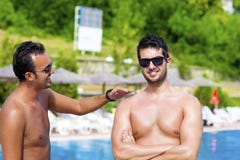 Young friends talking and having fun on the pool royalty free stock photography Young friends talking and having fun on the pool royalty free stock photography