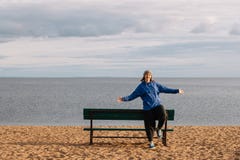 A young girl on the beach is photographed on a tourist trip walking along the shore, admiring nature royalty free stock photography A young girl on the beach is photographed on a tourist trip walking along the shore, admiring nature royalty free stock photography