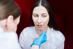 Young girl in the beauty parlor. Doctor humidifies lips gel. dentistry hygiene. stock image Young girl in the beauty parlor. Doctor humidifies lips gel. dentistry hygiene. stock image