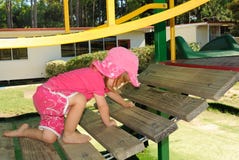 Young Girl Climbing On Playground Stock Photo