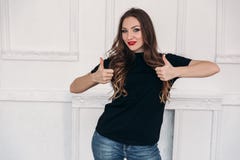 Young girl dressed in casual clothes, has long curled hair, red lips and gray eyes, is surprised by what is happening stock image Young girl dressed in casual clothes, has long curled hair, red lips and gray eyes, is surprised by what is happening stock image