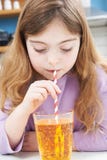 Young Girl Drinking Glass Of Soda Through Straw stock photo Young Girl Drinking Glass Of Soda Through Straw stock photo
