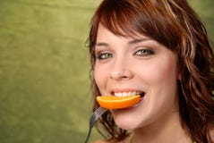 Young Girl Eating An Orange Stock Image