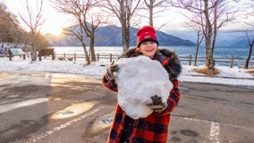 Young girl with giant snowball royalty free stock photos Young girl with giant snowball royalty free stock photos
