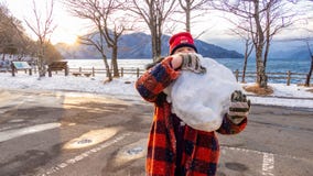 Young girl with giant snowball stock images Young girl with giant snowball stock images
