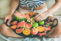 Young girl having healthy fruit breakfast in bed stock photos Young girl having healthy fruit breakfast in bed stock photos