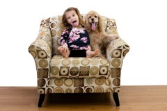 Young girl and her puppy relaxing in an armchair stock image Young girl and her puppy relaxing in an armchair stock image