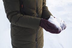 Young girl holding snow in her hands in mittens, winter, fun, joy, sports, recreation, children royalty free stock image Young girl holding snow in her hands in mittens, winter, fun, joy, sports, recreation, children royalty free stock image