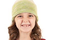 Young girl in knit hat missing one tooth stock photo Young girl in knit hat missing one tooth stock photo