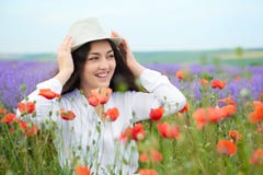 Young girl is in the lavender field, beautiful summer landscape with red poppy flowers Stock Images Young girl is in the lavender field, beautiful summer landscape with red poppy flowers Stock Images