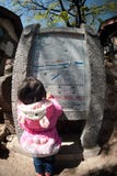 Young girl looking stone map in Lijiang Dayan old town.. Stock Photos Young girl looking stone map in Lijiang Dayan old town.. Stock Photos
