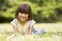 Young girl lying outdoors smiling royalty free stock image Young girl lying outdoors smiling royalty free stock image