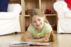 Young Girl Reading Book at Home royalty free stock image Young Girl Reading Book at Home royalty free stock image