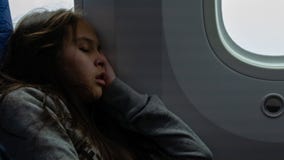 Young girl sleeping on airplane stock photography Young girl sleeping on airplane stock photography