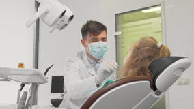 Young girl smiling to the camera after dental examination at the clinic stock video footage Young girl smiling to the camera after dental examination at the clinic stock video footage